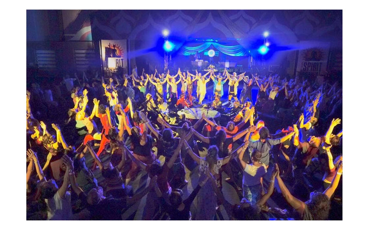 Participants forming connected circles at a Rainbow Yoga gathering.