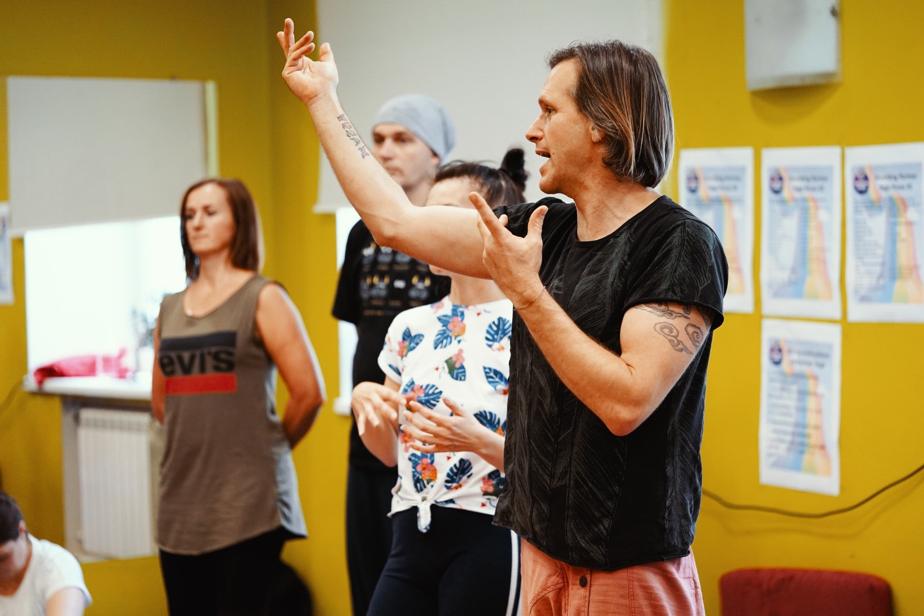 Gopala teaching Rainbow Yoga trainees in a bright training room
