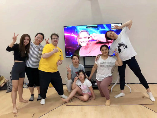 Rainbow Yoga graduates smiling together after a live training