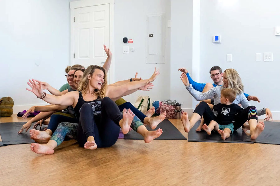 Adults learning Rainbow Yoga through movement, play and group connection
